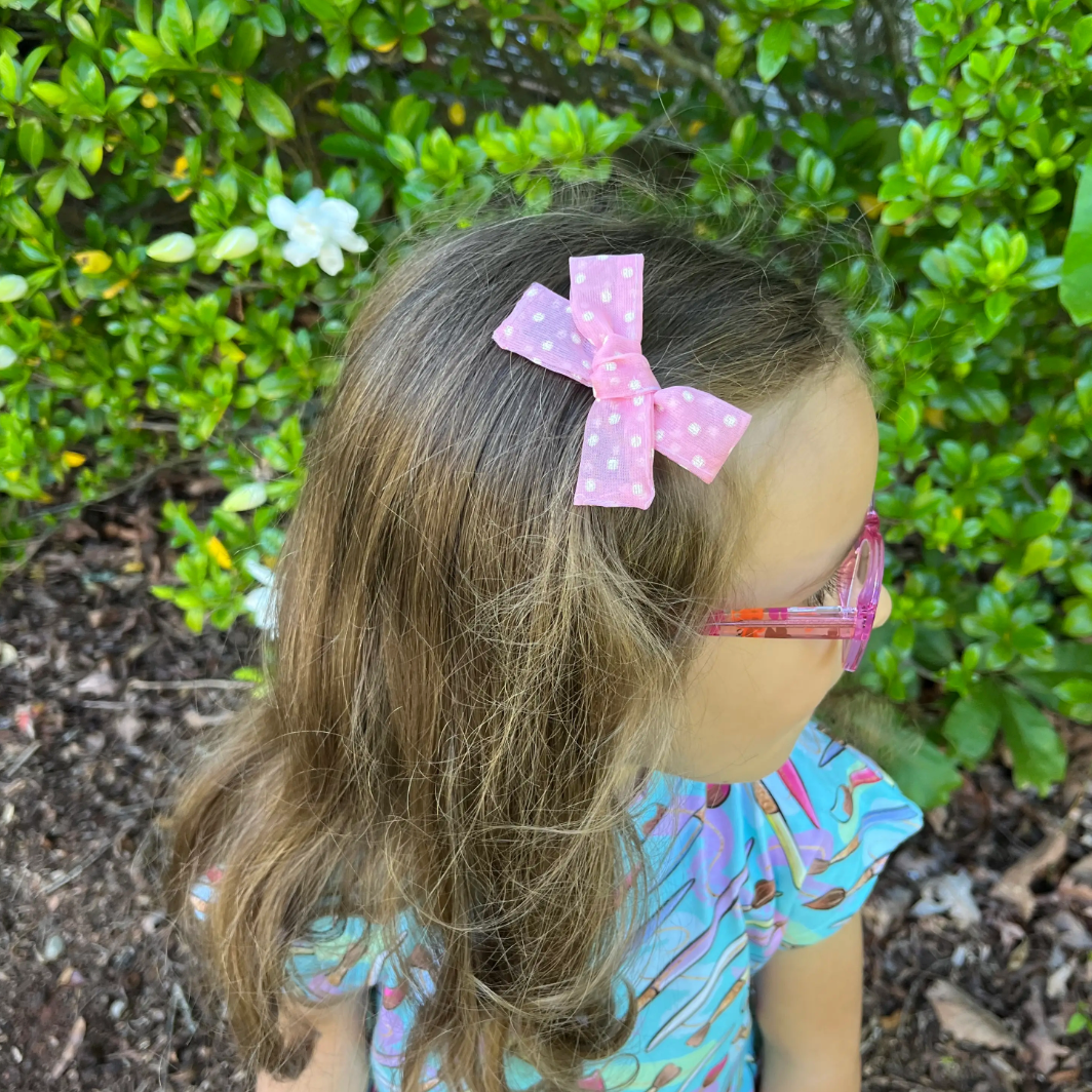 small hand-tied hair bow in pink sheer dot
