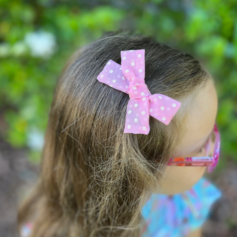 small hand-tied hair bow in pink sheer dot