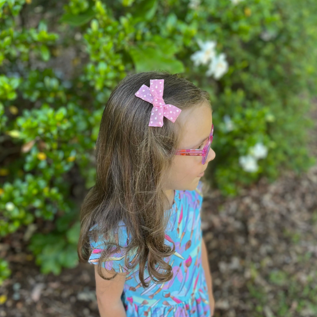 small hand-tied hair bow in pink sheer dot