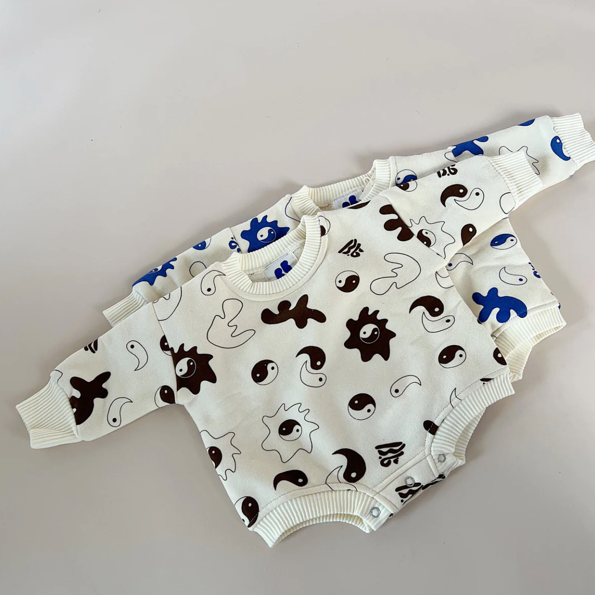 ying yang printed fleece romper in brown