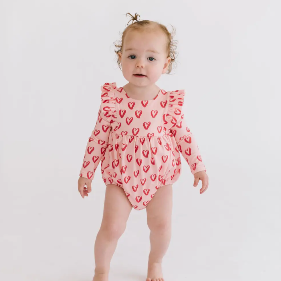 leah romper in happy hearts