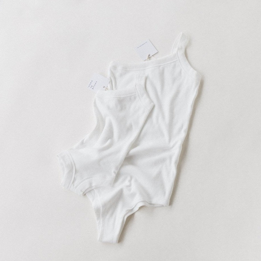 raised by water x shop kai blue one strap body suit