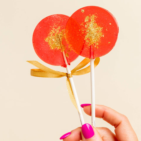 red & gold lollipops in passion fruit